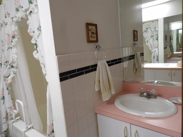 bathroom with tile walls and vanity