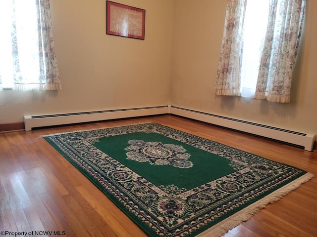 spare room featuring light hardwood / wood-style floors and plenty of natural light