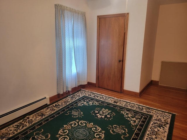 bedroom featuring a baseboard radiator and light wood-type flooring