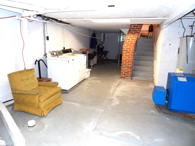 basement featuring gas water heater, brick wall, and separate washer and dryer