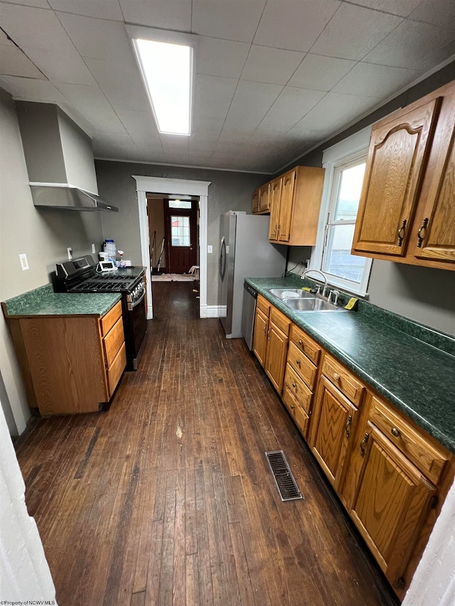 kitchen with stainless steel dishwasher, dark hardwood / wood-style floors, sink, and black stove