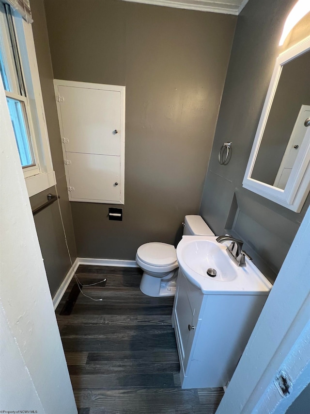 bathroom with hardwood / wood-style flooring, toilet, and vanity