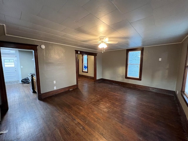 empty room with ceiling fan and dark wood-type flooring