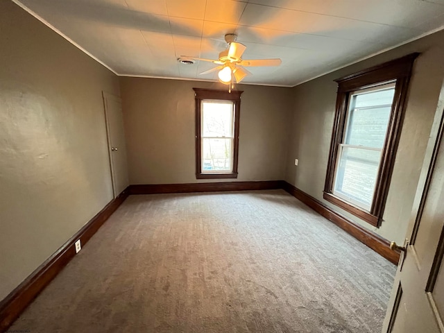 unfurnished room featuring ceiling fan and carpet