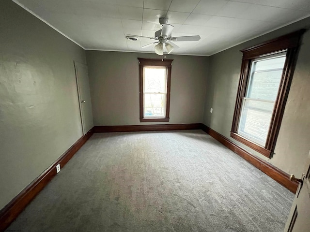 carpeted empty room featuring ceiling fan