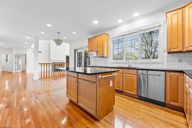 kitchen with backsplash, sink, a kitchen island, light hardwood / wood-style floors, and dishwasher