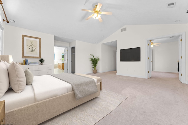 bedroom with lofted ceiling, ceiling fan, light carpet, and ensuite bathroom