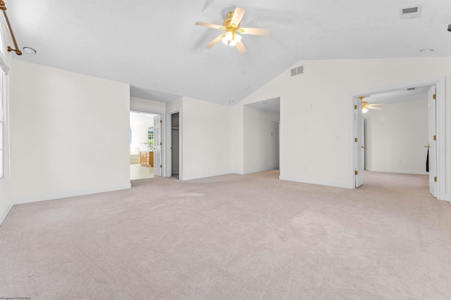 unfurnished room featuring light colored carpet, lofted ceiling, and ceiling fan