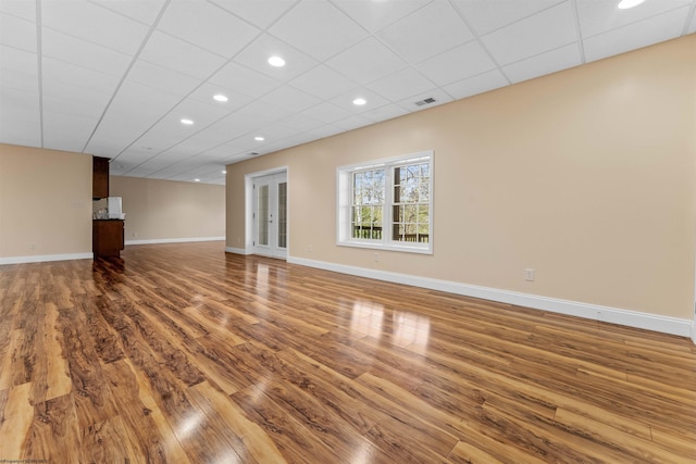 interior space with dark hardwood / wood-style floors and a paneled ceiling