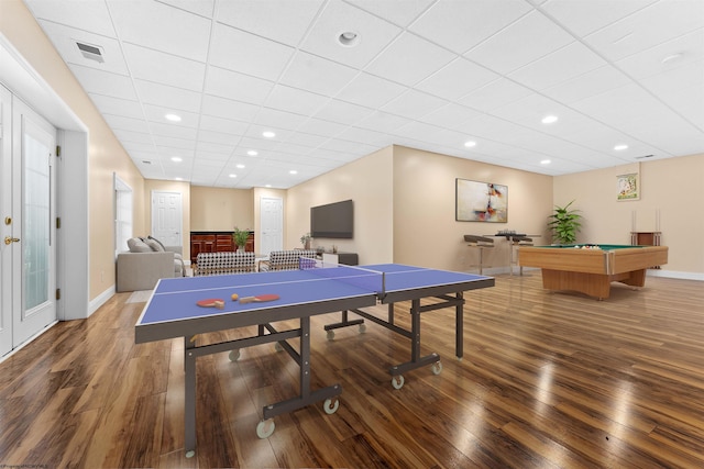 recreation room featuring hardwood / wood-style flooring, a drop ceiling, and pool table