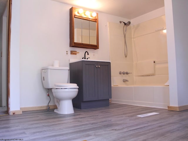 full bathroom featuring hardwood / wood-style flooring, vanity, toilet, and shower / bath combination