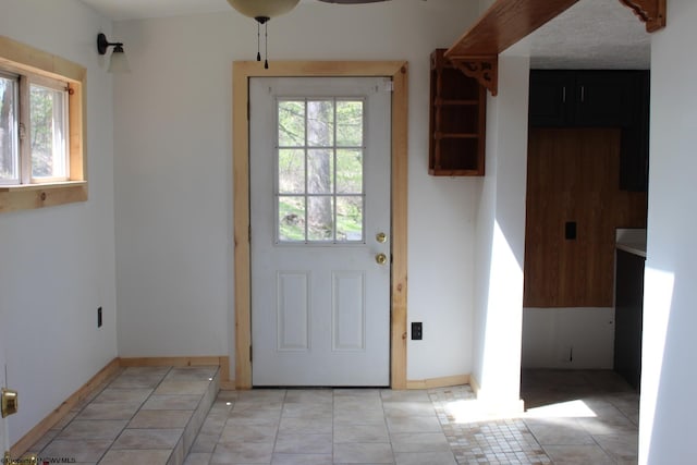 doorway with light tile patterned flooring