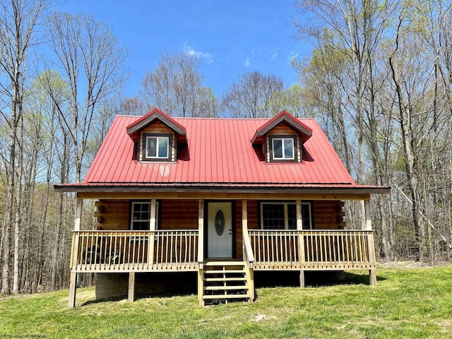 log cabin with a front yard and covered porch