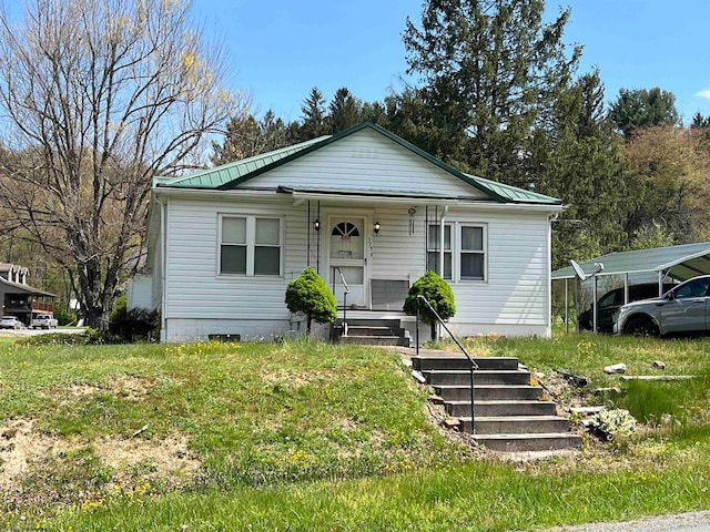 bungalow featuring a carport and a porch