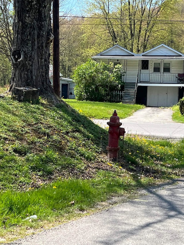 view of yard with covered porch and a garage