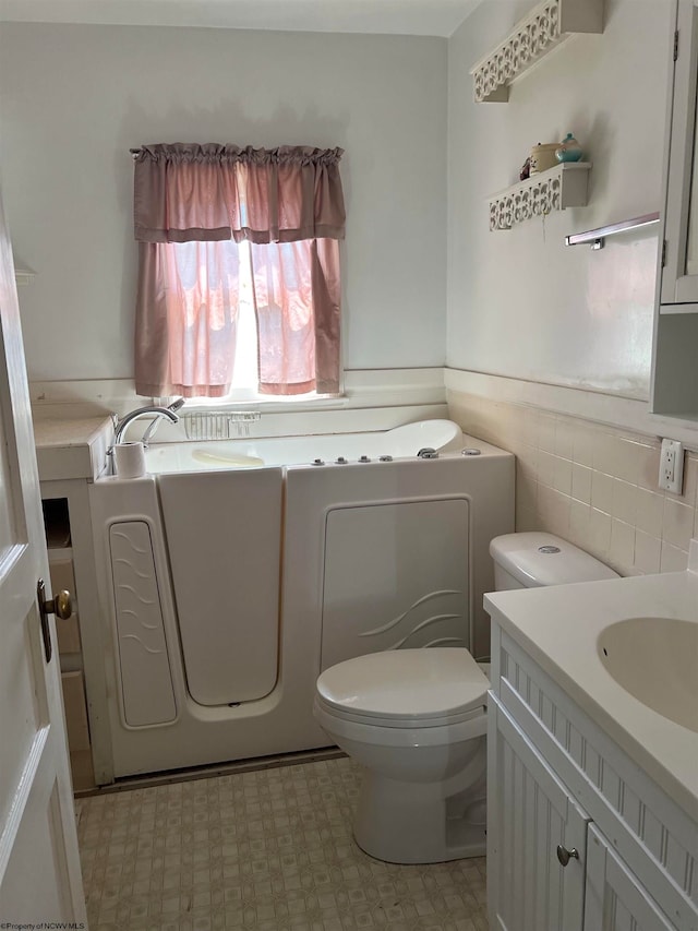 bathroom with tile flooring, vanity, backsplash, and toilet