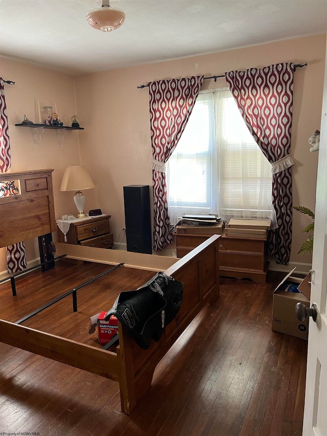 bedroom with dark hardwood / wood-style floors