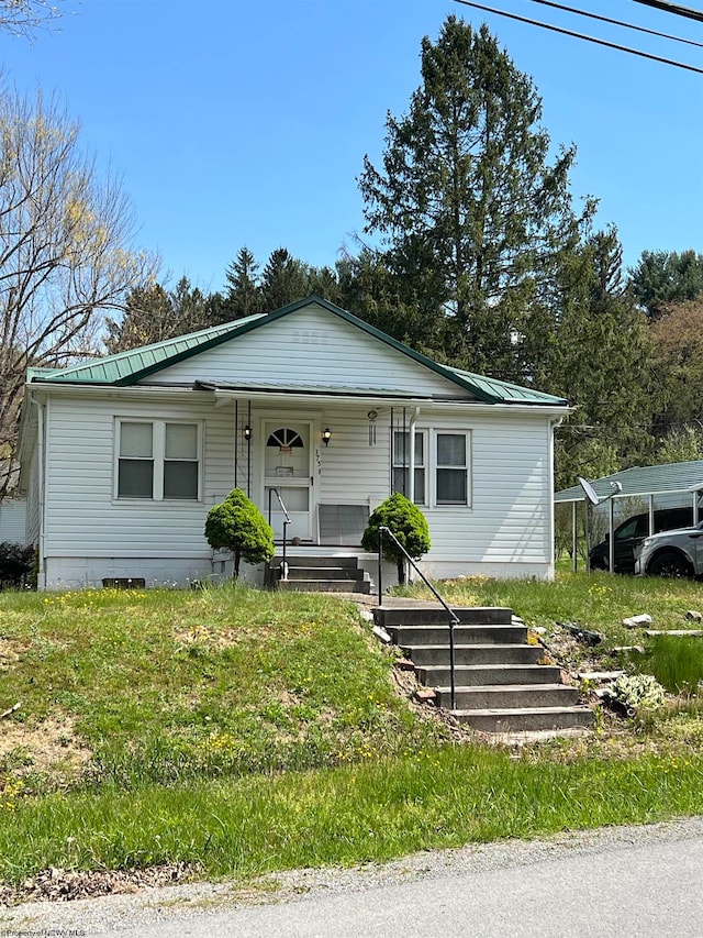 view of front of home featuring a carport and covered porch