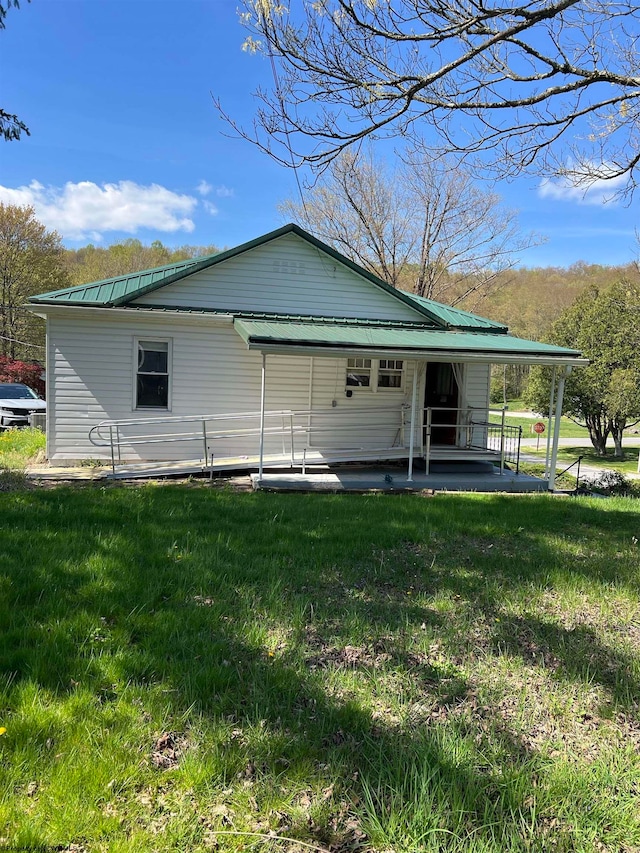 rear view of property featuring a yard