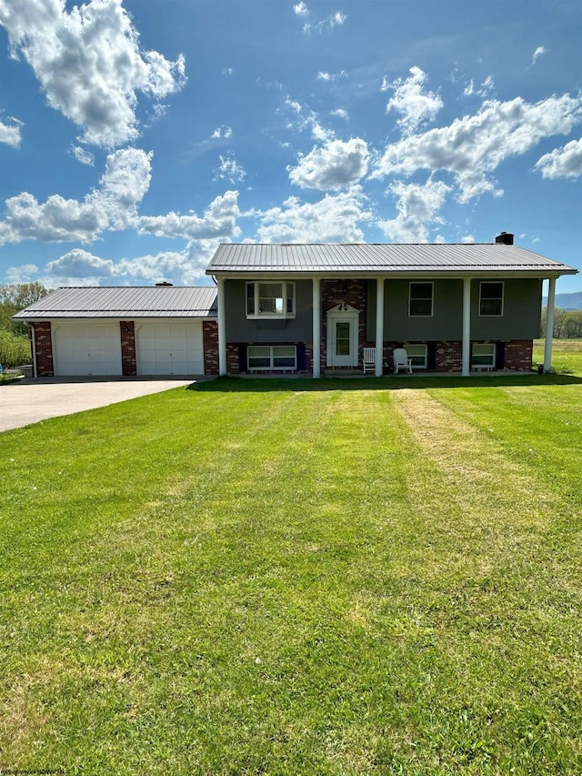 split foyer home featuring a front yard and a garage