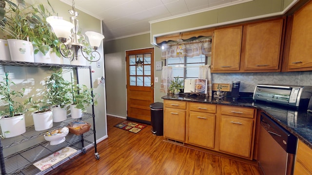 kitchen featuring a notable chandelier, tasteful backsplash, stainless steel dishwasher, crown molding, and hardwood / wood-style flooring