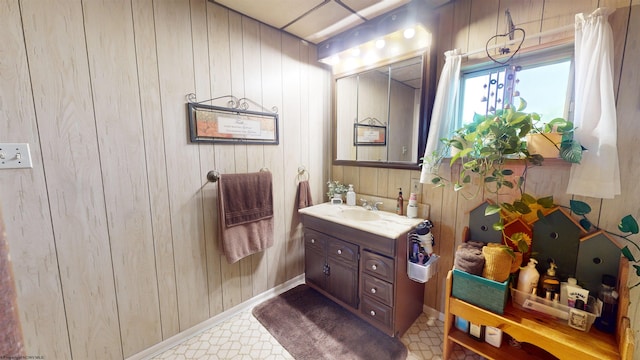 bathroom with vanity and wooden walls