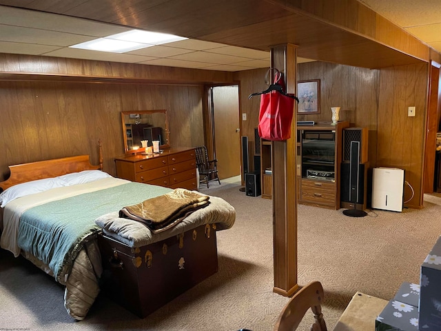 carpeted bedroom with wooden walls