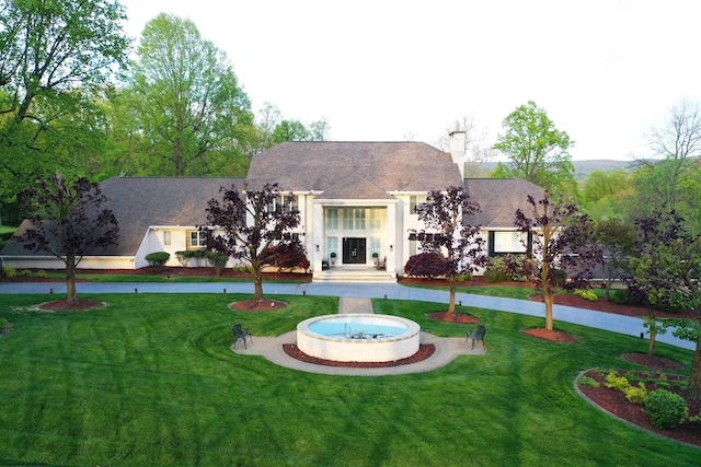 rear view of house with a yard