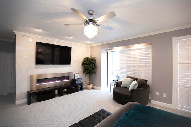 living room featuring ornamental molding, a premium fireplace, ceiling fan, and carpet floors