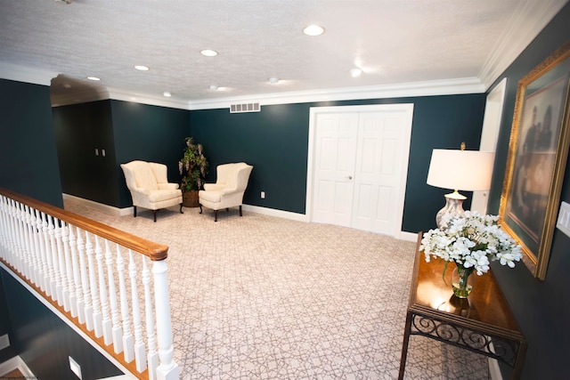 sitting room with ornamental molding and a textured ceiling