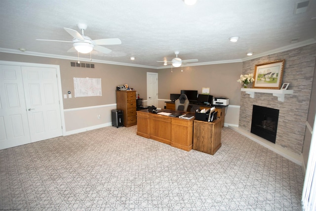 tiled home office featuring crown molding, ceiling fan, and a fireplace