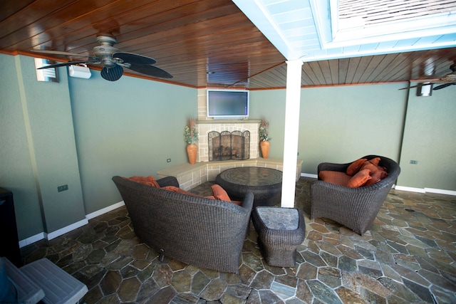 interior space featuring ceiling fan and a tile fireplace