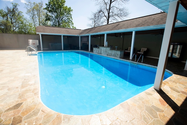 view of pool featuring a patio and a sunroom