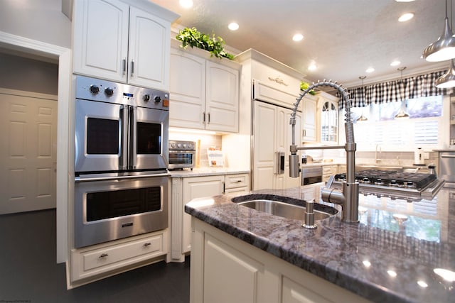 kitchen with hanging light fixtures, crown molding, backsplash, stainless steel appliances, and dark stone countertops