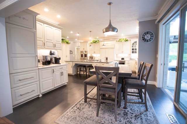 tiled dining space featuring ornamental molding