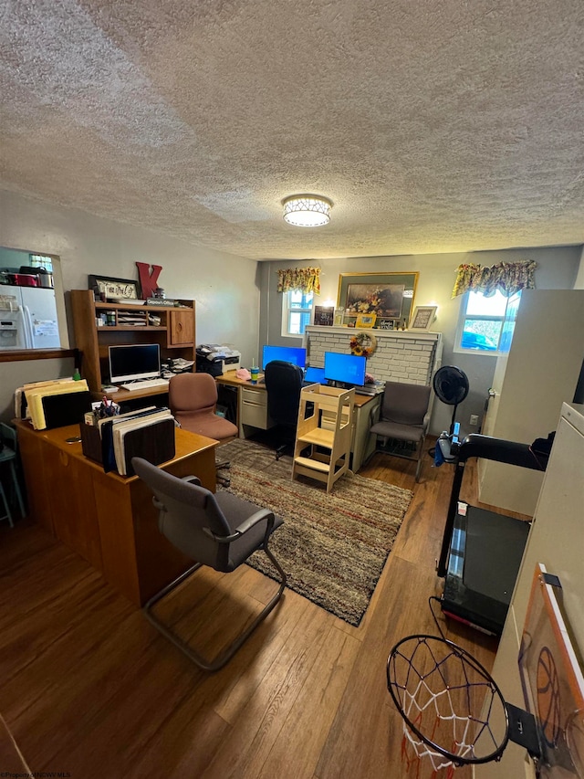 interior space featuring a textured ceiling and wood finished floors