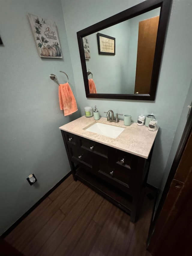 bathroom featuring wood finished floors and vanity