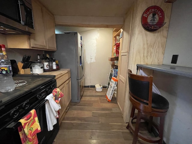 kitchen with appliances with stainless steel finishes and wood-type flooring