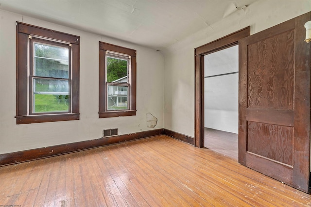 spare room featuring light hardwood / wood-style flooring