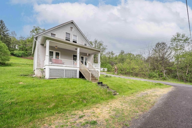 view of front of home featuring covered porch and a front lawn