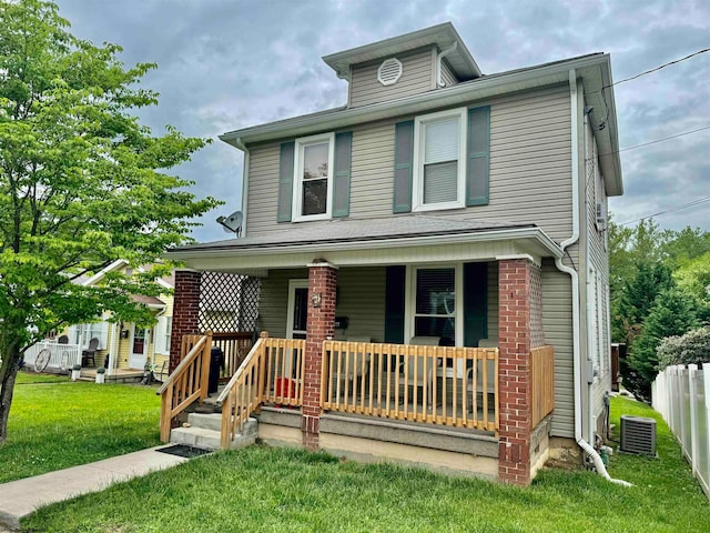 view of front of home with a porch and a front yard