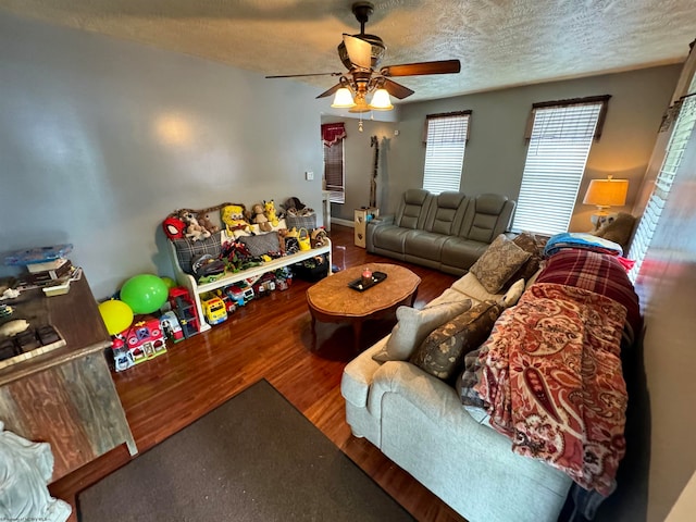 living room featuring a textured ceiling, ceiling fan, and hardwood / wood-style flooring