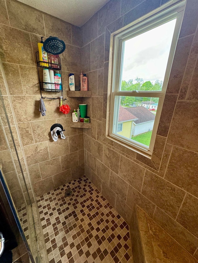 bathroom with tiled shower