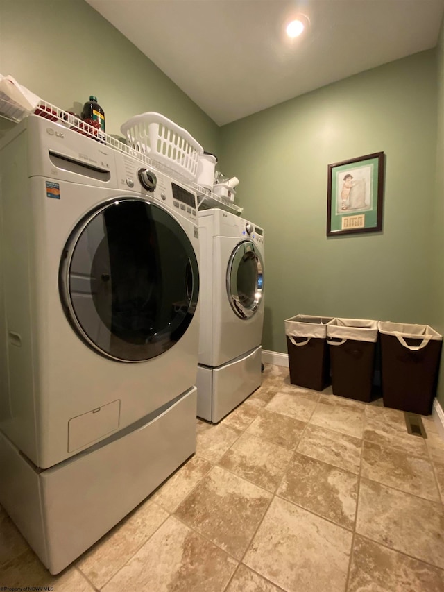 laundry area with tile floors and washer and dryer