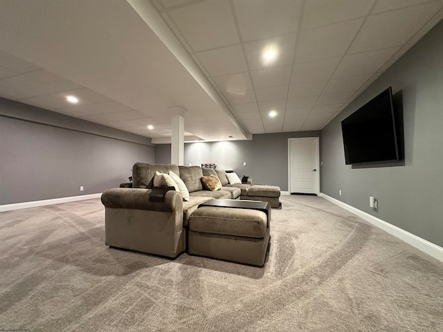 carpeted home theater featuring a drop ceiling