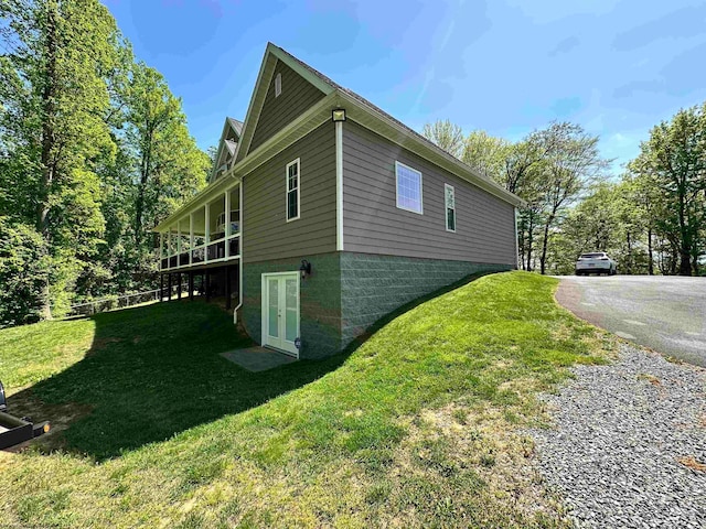 view of property exterior with a yard