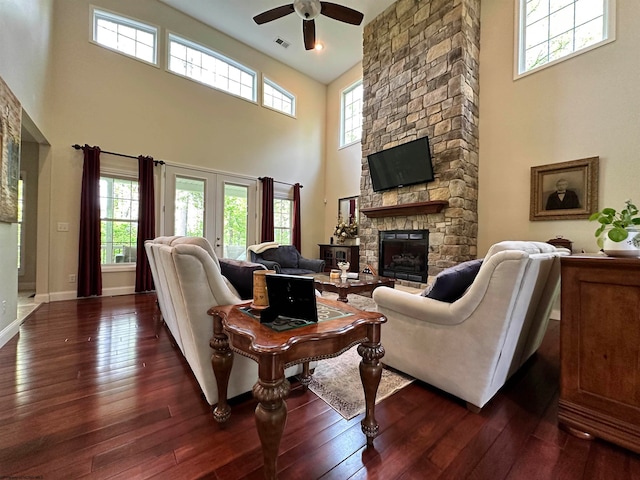 living room with plenty of natural light and dark hardwood / wood-style flooring