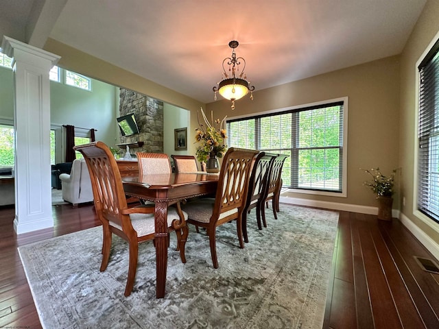 dining space with ornate columns and dark hardwood / wood-style floors