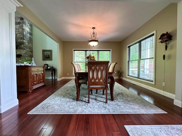 dining space with dark hardwood / wood-style floors