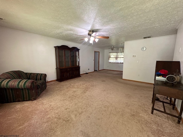 carpeted living room featuring ceiling fan and a textured ceiling